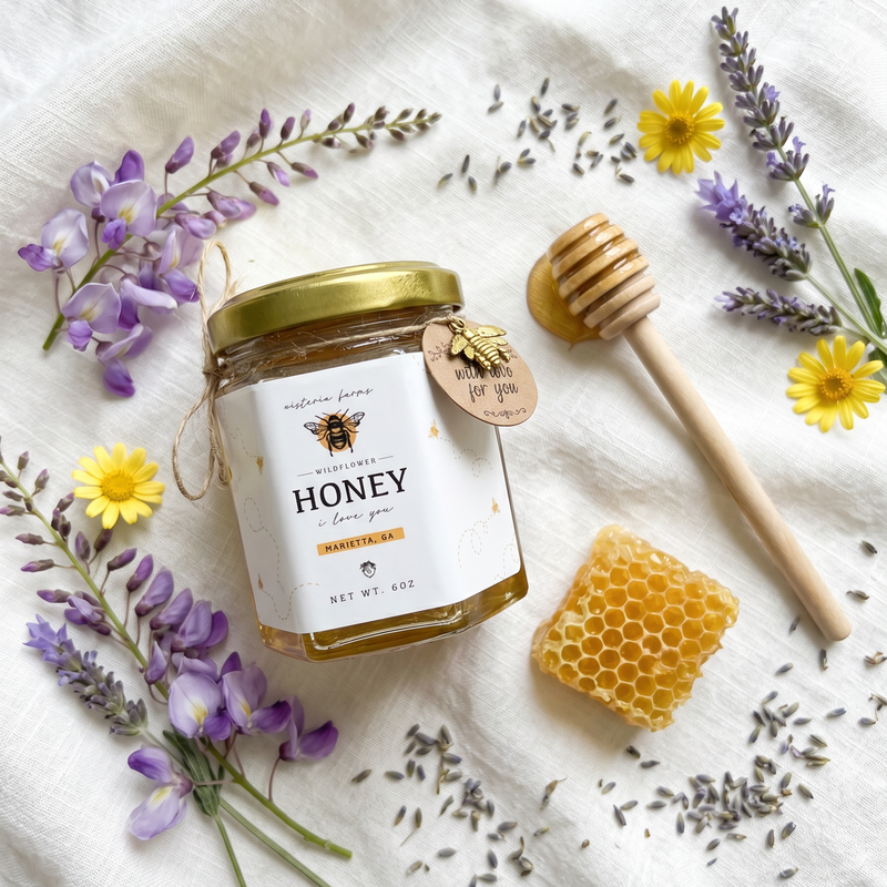 Honey jar with a honeycomb, dipper, and flowers on a white background