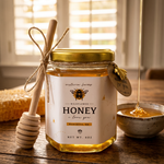 Jar of honey with a dipper on a wooden table, blurred background