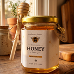 Jar of honey with a bee-themed label on a wooden surface